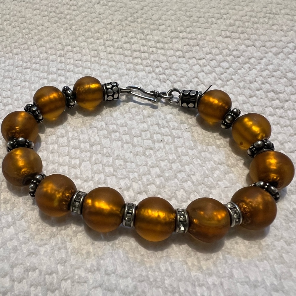 Rust frosted glass beads with silver and rhinestone stations bracelet. 6.5” long